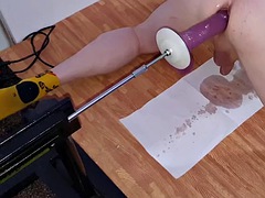 Squirts of urine while getting fucked in the ass with a big dildo on the fucking machine