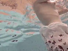 Blonde Okuneva shaved pussy swims underwater