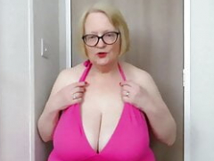 Sizeable granny tits in pink tankini.