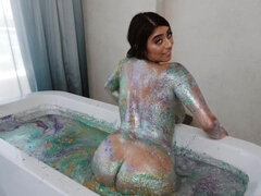 Busty latina takes a glitter bath before fucking