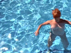 AuntJudys - Busty mature redhead Melanie goes swimming in the pool