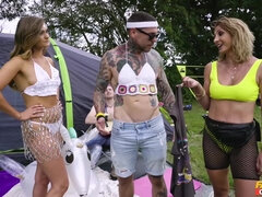 Victoria May and Marina Maya pleasuring tattooed guy outdoors