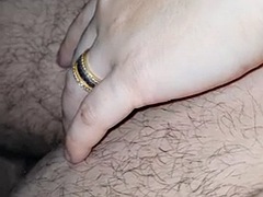 Stepmom is a horny bitch sitting with her naked stepson on the bed touching his cock
