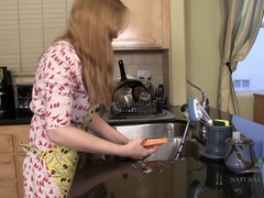 Heidi masturbates her hairy pussy in the kitchen.