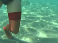 Red stocking in the sea on a public beach