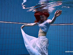 The redhead Marketa in a white dress in the pool