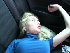 A blonde with large titties is getting fucked in the back of a car