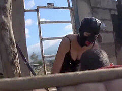 masked princess in leather caning her slave