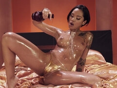Honey Gold gets oiled up and pleasantly fucked in bed