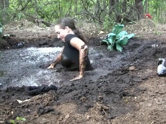 Busty Samantha gets very dirty outdoors in pool of mud