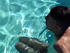 Swimming in the hot pool and wanking his dick with a skinny twink