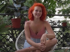 Redhead babe rubs her pussy on balcony