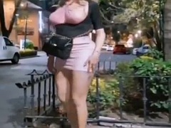 Transexual standing in front of a meeting place to have pornographic sex