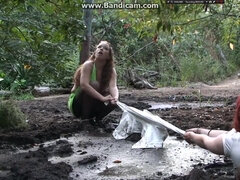 Two amateur babes getting dirty & drowning in mud outdoor