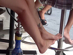 Candid legs and soles draping insert sandals in miniskirt