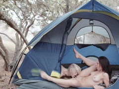 Two passionate lesbians with natural tits make love all over the camping site