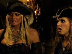 Two sexy pirate chicks are in a threesome, handling a cock