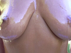 Big titted brunette likes to get oiled